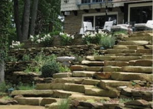 Blend natural stone steps with outcropping and wall stone to create a beautiful landscape.